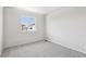 Comfortable bedroom with neutral carpet, white walls, and window with neighborhood view at 8787 Whiteclover St, Littleton, CO 80125