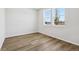 Bright bedroom with hardwood floors and ample natural light from two windows at 8787 Whiteclover St, Littleton, CO 80125