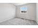 Cozy bedroom with neutral carpeting and a window overlooking the neighborhood at 8787 Whiteclover St, Littleton, CO 80125