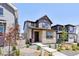 Charming two-story home featuring stone accents, landscaped front yard, and welcoming entrance at 8787 Whiteclover St, Littleton, CO 80125