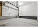 Spacious unfinished garage with stairs leading to the house and modern garage door opener at 8787 Whiteclover St, Littleton, CO 80125