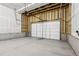 Empty two car garage with concrete flooring and a white garage door at 8787 Whiteclover St, Littleton, CO 80125