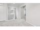 Hallway with gray carpet, white walls, and access to multiple rooms at 8787 Whiteclover St, Littleton, CO 80125