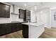 Stylish kitchen with dark cabinetry, white countertops, and stainless steel appliances at 8787 Whiteclover St, Littleton, CO 80125