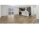 Open-concept layout connecting living room to kitchen, with modern finishes and lighting at 8787 Whiteclover St, Littleton, CO 80125