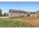 View of the backyard showing a shed and patchy grass at 272 Balsam Ave, Brighton, CO 80601
