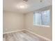 Finished basement with egress window, light gray wood-look flooring, and neutral walls at 272 Balsam Ave, Brighton, CO 80601