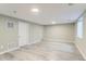 Spacious finished basement area with light gray wood-look flooring, neutral walls, and recessed lighting at 272 Balsam Ave, Brighton, CO 80601