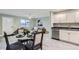 Open dining area is bright with views of living room and modern kitchen at 272 Balsam Ave, Brighton, CO 80601