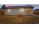 Charming home with a large boulder, freshly laid topsoil, new windows and inviting orange front door at 272 Balsam Ave, Brighton, CO 80601
