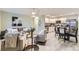Sun-lit living room seamlessly flows into the modern kitchen with stainless steel appliances at 272 Balsam Ave, Brighton, CO 80601
