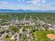 Scenic aerial view of a town nestled among trees, with mountains in the distance at 1101 Spruce St, Louisville, CO 80027