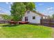Lush backyard offering a deck, mature tree, and a well-kept lawn at 1101 Spruce St, Louisville, CO 80027