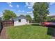 Spacious backyard featuring a well-maintained lawn, mature tree, privacy fence, and access to a detached garage at 1101 Spruce St, Louisville, CO 80027