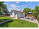 Backyard with a detached garage, patio set, and well-manicured lawn at 1101 Spruce St, Louisville, CO 80027