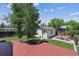 Landscaped backyard with a red deck, patio, and green lawn at 1101 Spruce St, Louisville, CO 80027
