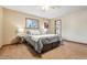 Inviting bedroom with carpet, a ceiling fan, and a view of the ensuite bathroom at 1101 Spruce St, Louisville, CO 80027