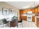Eat-in kitchen featuring tile flooring, wooden cabinets, and modern white appliances at 1101 Spruce St, Louisville, CO 80027