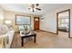 Bright living room with a wood door, neutral carpet and access to another bedroom at 1101 Spruce St, Louisville, CO 80027
