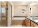 Bright bathroom with a soaking tub, glass enclosed shower, double sinks, and vanity with plenty of storage at 2276 S Norse St, Lakewood, CO 80228