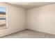 Cozy bedroom with neutral carpet and natural light from the window at 2276 S Norse St, Lakewood, CO 80228