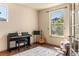 Cozy bedroom with a piano and a guitar next to a large window allowing ample natural light at 2276 S Norse St, Lakewood, CO 80228