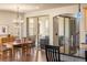 Dining area next to kitchen features a stylish chandelier and sliding glass doors to the patio at 2276 S Norse St, Lakewood, CO 80228