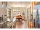 Open concept dining room with tile floors, chandelier, and sliding glass doors to the patio at 2276 S Norse St, Lakewood, CO 80228