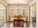 Bright dining room featuring an elegant chandelier, wooden table with chairs, and a sliding glass doors to the patio at 2276 S Norse St, Lakewood, CO 80228