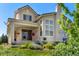 Back exterior of stucco home with lush landscaping and a covered patio at 2276 S Norse St, Lakewood, CO 80228