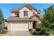 Charming two-story home with a stone facade, attached two-car garage, and well-maintained landscaping at 2276 S Norse St, Lakewood, CO 80228