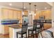 Open kitchen with light cabinets, an island with black bar stools, and stainless steel appliances for modern living at 2276 S Norse St, Lakewood, CO 80228