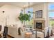 Spacious living room with stone fireplace, a ceiling fan, and lots of natural light at 2276 S Norse St, Lakewood, CO 80228