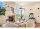 Spacious living room with stone fireplace, high ceilings, and large windows with views of the mountains at 2276 S Norse St, Lakewood, CO 80228