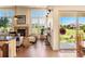 Sunlit living room featuring a stone fireplace, large windows with outdoor views, and tiled floors at 2276 S Norse St, Lakewood, CO 80228