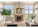 Comfortable living room with stone fireplace, large windows, and open space with scenic outside views at 2276 S Norse St, Lakewood, CO 80228