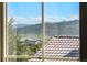 Window view showcasing the neighborhood, distant mountains, and blue skies on a sunny day at 2276 S Norse St, Lakewood, CO 80228