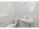 Clean and modern half-bathroom with a pedestal sink and natural light at 7596 Grady Cir, Castle Rock, CO 80108