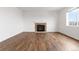 A cozy living room with a stone fireplace and wood-look flooring at 7596 Grady Cir, Castle Rock, CO 80108