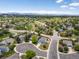 Expansive aerial view of a suburban neighborhood with mature trees and mountain views in the distance at 2006 E 97Th Ave, Thornton, CO 80229