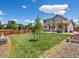 Spacious backyard with a pergola, wooden fence, and lush green grass, perfect for entertaining outdoors at 2006 E 97Th Ave, Thornton, CO 80229