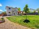 Lush backyard features a green lawn, a wooden pergola, and gravel landscaping at 2006 E 97Th Ave, Thornton, CO 80229