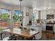 Bright kitchen featuring modern appliances, a large dining table, and ample natural light at 2006 E 97Th Ave, Thornton, CO 80229