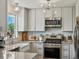 Modern kitchen featuring stainless steel appliances, light countertops, and decorative backsplash at 2006 E 97Th Ave, Thornton, CO 80229