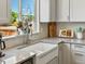 Cozy kitchen corner with stainless steel appliances, white cabinets, and a charming window view at 2006 E 97Th Ave, Thornton, CO 80229