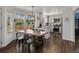 Modern kitchen and dining area with light cabinetry, stainless steel appliances, and a large dining table at 2006 E 97Th Ave, Thornton, CO 80229
