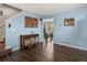 Entryway with blue walls, a console table, and dark hardwood floors that extend into the dining area at 2006 E 97Th Ave, Thornton, CO 80229