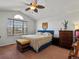 Spacious bedroom with a large window, soft carpet, and a cozy queen sized bed at 2006 E 97Th Ave, Thornton, CO 80229