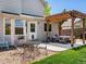 Outdoor patio with pergola, stone area, and seating, creating a relaxing entertainment space at 2006 E 97Th Ave, Thornton, CO 80229