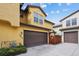 Exterior showcasing a well-maintained stucco home with a two-car garage and manicured landscaping at 9654 Martin Luther King Jr Blvd, Denver, CO 80238
